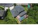 Aerial view of property with screened-in pool, manicured lawn, and mature trees, showing privacy at 16102 Colchester Palms Dr, Tampa, FL 33647
