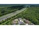 Aerial view of a neighborhood near a highway with easy access to a nearby pond at 16102 Colchester Palms Dr, Tampa, FL 33647