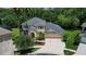 Aerial view of home showcasing lush landscaping, spacious driveway, and a well-maintained exterior at 16102 Colchester Palms Dr, Tampa, FL 33647