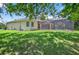 Spacious backyard features a screened pool and ample greenery, providing a private oasis at 16102 Colchester Palms Dr, Tampa, FL 33647