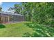 Beautiful backyard with grassy area and screened pool, offering a serene outdoor living space at 16102 Colchester Palms Dr, Tampa, FL 33647