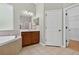 Bathroom featuring a soaking tub, vanity and access to a walk-in closet at 16102 Colchester Palms Dr, Tampa, FL 33647