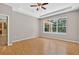 Well-lit bedroom featuring a large window overlooking the backyard at 16102 Colchester Palms Dr, Tampa, FL 33647