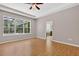 Primary bedroom featuring a tray ceiling, ceiling fan, and private bath at 16102 Colchester Palms Dr, Tampa, FL 33647