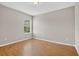 Bedroom with light grey paint, wood-look flooring, and large window at 16102 Colchester Palms Dr, Tampa, FL 33647