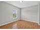 Empty bedroom featuring a window, laminate flooring, and neutral paint at 16102 Colchester Palms Dr, Tampa, FL 33647