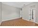 Bedroom with light grey paint, wood-look flooring, and white doors and trim at 16102 Colchester Palms Dr, Tampa, FL 33647