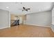 Large bonus room with wood-look floors, and railing overlooking stairs at 16102 Colchester Palms Dr, Tampa, FL 33647