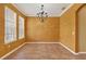 Bright dining room featuring neutral tile floors, large windows for natural light, and elegant chandelier at 16102 Colchester Palms Dr, Tampa, FL 33647