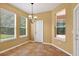 Bright dining area featuring multiple windows with outdoor views and decorative chandelier at 16102 Colchester Palms Dr, Tampa, FL 33647