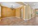 Open dining area features decorative chandelier, tile floors, and arched doorway at 16102 Colchester Palms Dr, Tampa, FL 33647