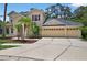 Charming two-story home with a three car garage, palm trees, and manicured lawn at 16102 Colchester Palms Dr, Tampa, FL 33647