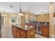 Modern kitchen with an island, stainless steel appliances, granite countertops, and ample windows at 16102 Colchester Palms Dr, Tampa, FL 33647