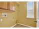 Functional laundry room with storage cabinets, shelving, and window for natural light at 16102 Colchester Palms Dr, Tampa, FL 33647