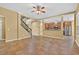 Open living area with a staircase and views into the modern kitchen at 16102 Colchester Palms Dr, Tampa, FL 33647
