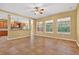 Bright living room with kitchen views and multiple windows overlooking outdoor pool area at 16102 Colchester Palms Dr, Tampa, FL 33647