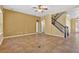 Spacious living room with tile flooring and staircase access to the upper level at 16102 Colchester Palms Dr, Tampa, FL 33647