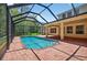 Inviting pool inside screened enclosure, adjacent to brick patio creates an ideal backyard retreat at 16102 Colchester Palms Dr, Tampa, FL 33647