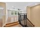 Staircase with black railings and natural wood steps that lead to a bonus room at 16102 Colchester Palms Dr, Tampa, FL 33647
