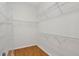 Walk-in closet with wire shelving and laminate flooring at 16102 Colchester Palms Dr, Tampa, FL 33647