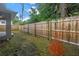 Large fenced backyard with mature trees providing shade and privacy at 1717 Preston S St, St Petersburg, FL 33712