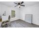 This bedroom has light wood floors, a ceiling fan, and a window with natural light at 1717 Preston S St, St Petersburg, FL 33712
