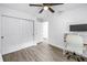 This bedroom has light wood floors, a ceiling fan, and a double door closet at 1717 Preston S St, St Petersburg, FL 33712