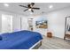 This primary bedroom offers light wood floors, a ceiling fan, and a spacious bathroom featuring tiled shower at 1717 Preston S St, St Petersburg, FL 33712