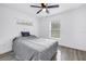 This bedroom features light wood floors, a ceiling fan, and windows at 1717 Preston S St, St Petersburg, FL 33712