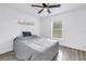 This bedroom features light wood floors, a ceiling fan, and windows at 1717 Preston S St, St Petersburg, FL 33712