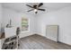 This bedroom has light wood floors, a ceiling fan, and a window with natural light at 1717 Preston S St, St Petersburg, FL 33712