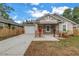 View of home, featuring a driveway, single car garage and a well-manicured yard with grass and mulch at 1717 Preston S St, St Petersburg, FL 33712