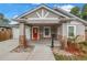 Charming single-story home featuring a bright red door, stone accents, and well-manicured landscaping at 1717 Preston S St, St Petersburg, FL 33712