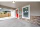 Covered front porch with a bright red door, stone accents and lighting at 1717 Preston S St, St Petersburg, FL 33712
