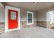 Cozy front porch featuring a bright red door, stone accents and plenty of sunlight at 1717 Preston S St, St Petersburg, FL 33712