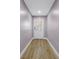 Hallway featuring wood-look floors, leading to the front door at 1717 Preston S St, St Petersburg, FL 33712
