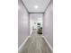 Hallway featuring wood-look floors, leading to the living room at 1717 Preston S St, St Petersburg, FL 33712