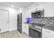 Well-equipped kitchen with stainless steel appliances, granite countertops, and white cabinetry at 1717 Preston S St, St Petersburg, FL 33712