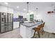 Bright kitchen featuring white cabinets, stainless steel appliances, and a granite countertop island with bar seating at 1717 Preston S St, St Petersburg, FL 33712