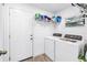 The laundry room features a window for natural light and white washer and dryer at 1717 Preston S St, St Petersburg, FL 33712