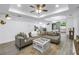 Comfortable living room with a large sectional sofa, tray ceiling, and a view of the dining area at 1717 Preston S St, St Petersburg, FL 33712