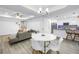 Open-concept living area with modern decor, light wood floors, a tray ceiling, and a view of the kitchen at 1717 Preston S St, St Petersburg, FL 33712