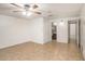Bedroom featuring a ceiling fan, tile flooring, and an ensuite bathroom at 1741 Font Ln, Holiday, FL 34691