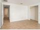 Spacious bedroom with tile floor, closet, and an open doorway, offering ample space and natural light at 1741 Font Ln, Holiday, FL 34691
