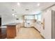 Open kitchen with a center island, modern appliances, and an adjacent dining area at 1741 Font Ln, Holiday, FL 34691
