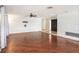 Large living room features hardwood floors, a ceiling fan, and ample natural light at 1741 Font Ln, Holiday, FL 34691