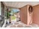 Outdoor patio with stone tile and enclosed porch with view to grassy backyard and fence at 1741 Font Ln, Holiday, FL 34691