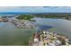 Expansive aerial view of a coastal community featuring stunning waterfront homes, waterways, and lush greenery at 17715 Wall Cir, Redington Shores, FL 33708