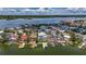 A picturesque waterfront community with stunning homes, private docks, and serene water views under a sunny sky at 17715 Wall Cir, Redington Shores, FL 33708