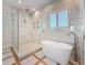 A luxurious bathroom with a soaking tub, walk-in shower, and elegant marble accents at 17715 Wall Cir, Redington Shores, FL 33708